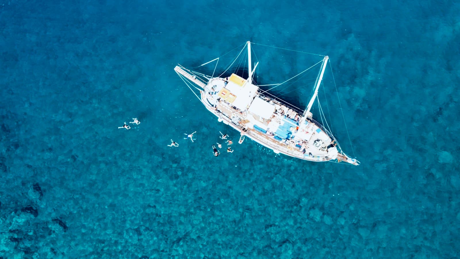 A sailing yacht at anchor in clear blue water